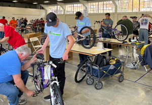 Volunteers assembling bikes to be donated to needy children.