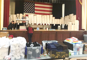 Volunteers at the Veterans hall in Pleasanton pack care packages for deployed troops.